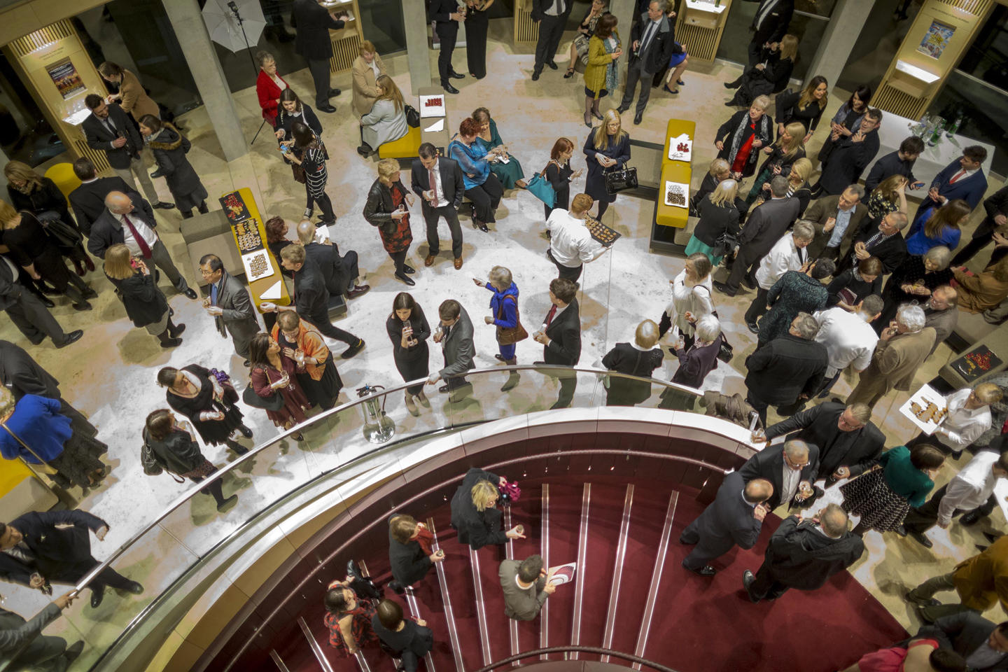 Audience members gathered in an upper level in Theatre Royal Glasgow, looking down the main spiral staircase