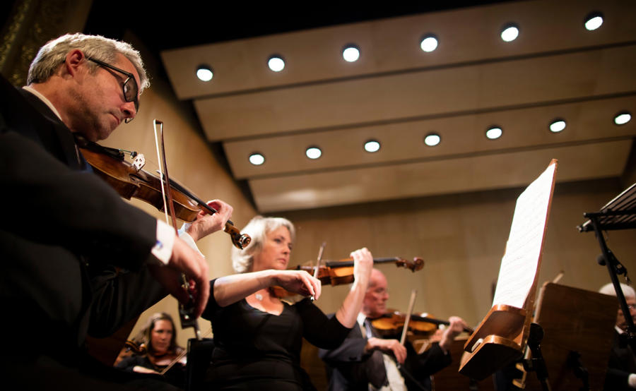 Violinists playing in The Orchestra of Scottish Opera