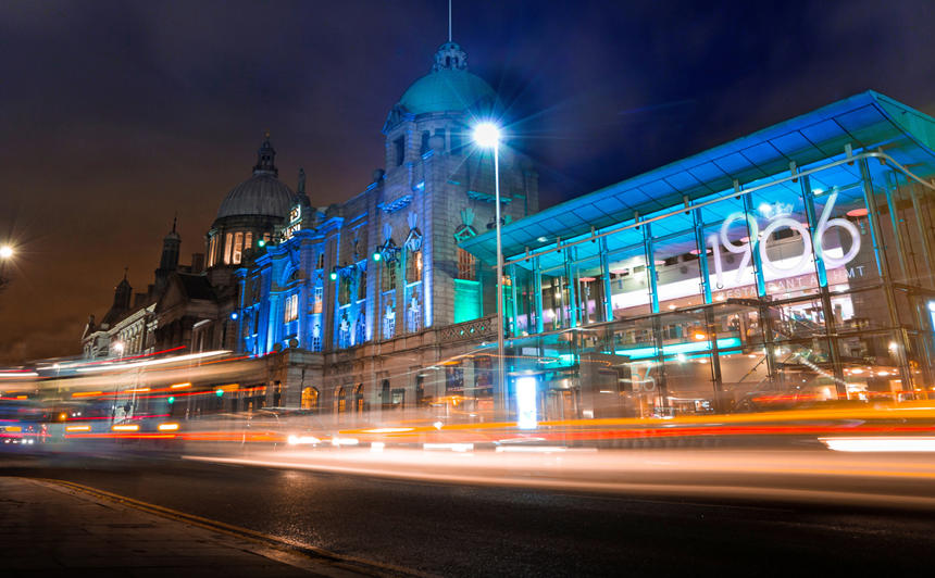 His Majesty's Theatre in Aberdeen illuminated at night time with lights from traffic streaming past