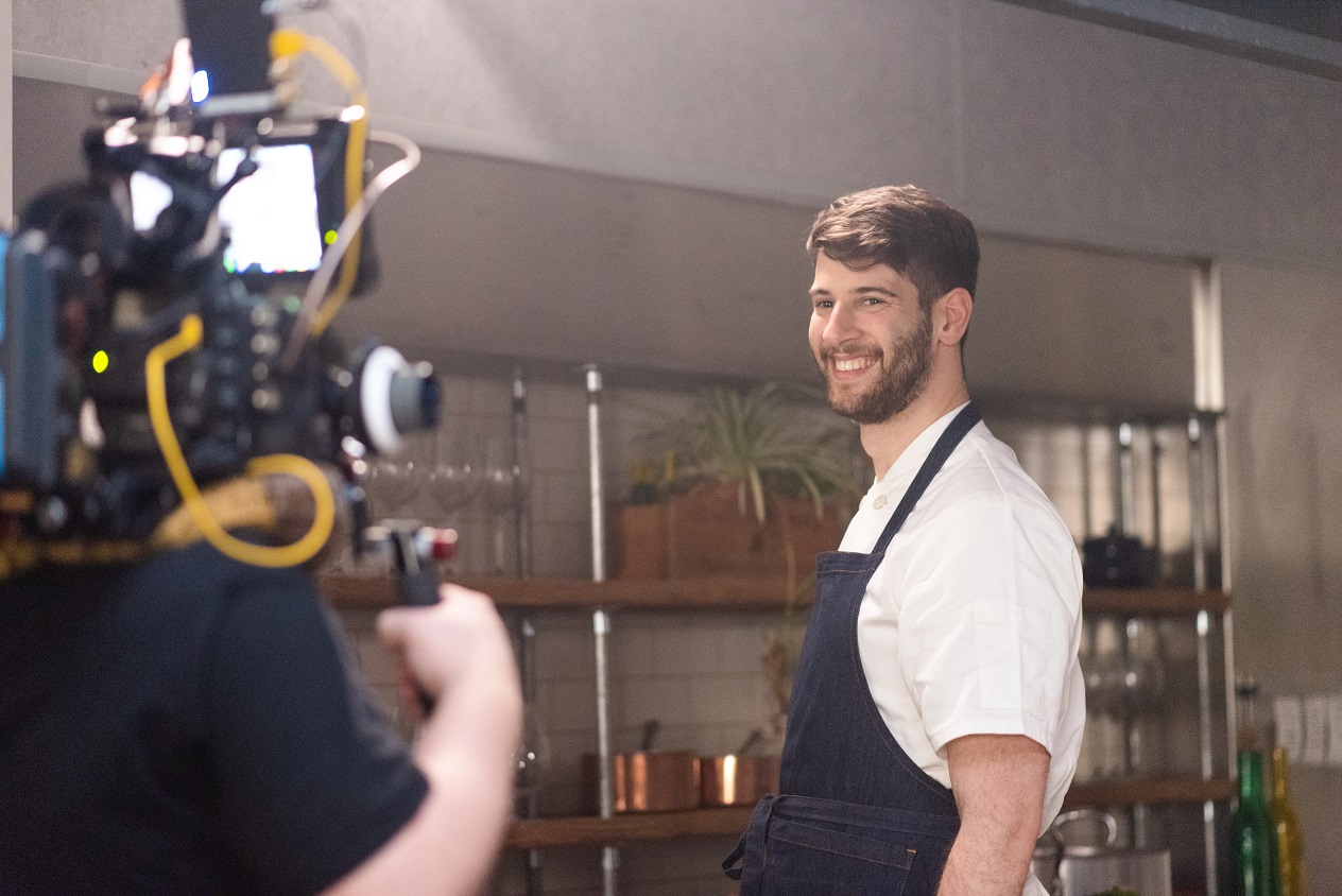 Mark Nathan smiling for the camera behind the scenes of The Narcissistic Fish