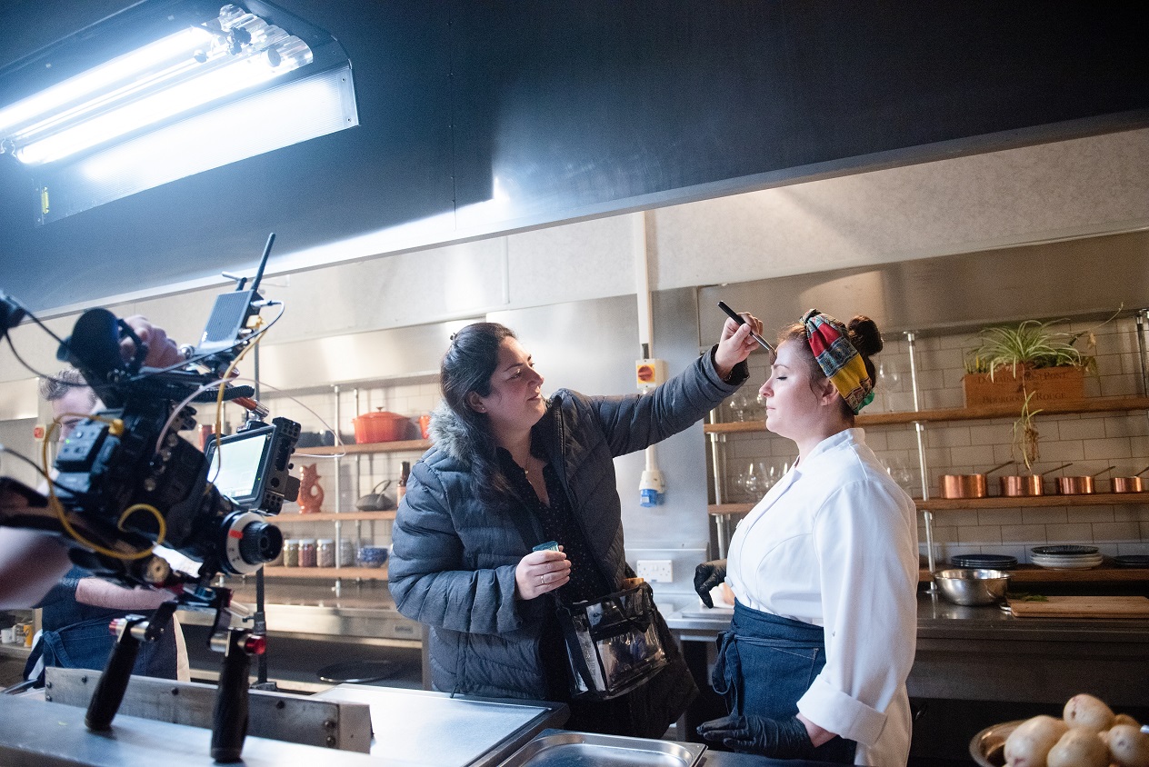 Soprano Charlie Drummond getting her make-up touched up during filming of The Narcissistic Fish