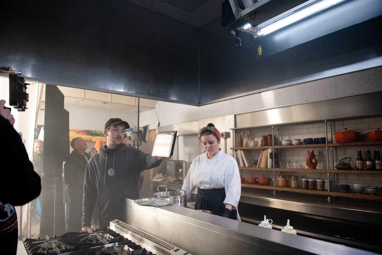 Soprano Charlie Drummond and the camera crew in a kitchen during filming of The Narcissistic Fish