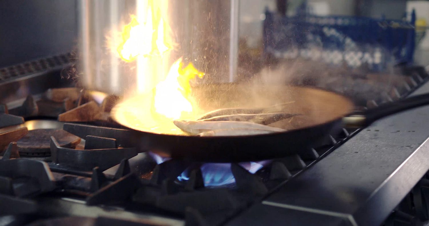 Fish searing in a pan